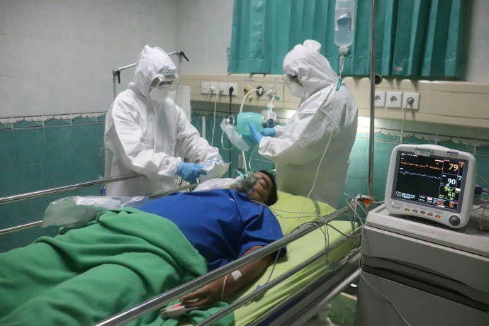 man in white medical scrub lying on hospital bed